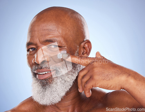 Image of Beauty, cream and portrait of black man in studio for sunscreen, anti aging or skincare. Cosmetics, mockup or self care with lotion on face of model on blue background for facial, spa and product