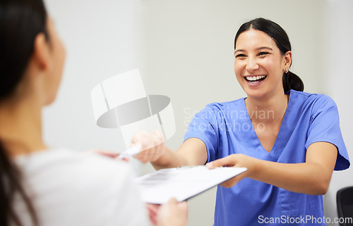 Image of Documents, happy and a nurse helping a patient in the hospital during an appointment or checkup. Insurance form, smile and a medical assistant at a health clinic to help with check in or sign up