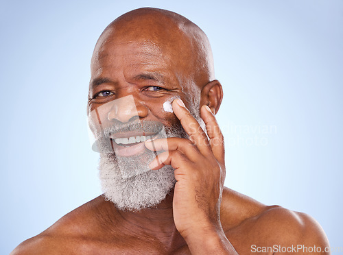 Image of Skincare, beauty and portrait of black man and cream in studio for sunscreen, anti aging or spa. Cosmetics, mockup or self care with lotion on face of model on blue background for facial and product