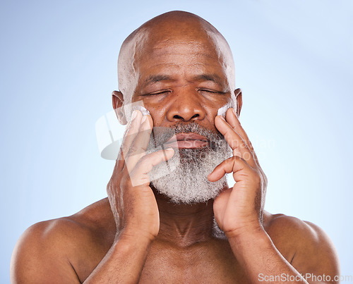 Image of Skincare, cream and beauty with black man in studio for sunscreen anti aging or spa. Cosmetics, mockup or self care with lotion on face of senior model on blue background for facial and product