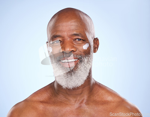 Image of Skincare, cream and smile with portrait of black man in studio for sunscreen, anti aging or beauty. Cosmetics, mockup or self care with face lotion model on blue background for facial and spa product