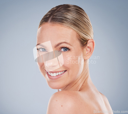 Image of Beauty, skincare and portrait of woman in studio for facial, cosmetics and natural makeup. Self care, wellness and mockup with face of female model on grey background for glow, happiness and collagen