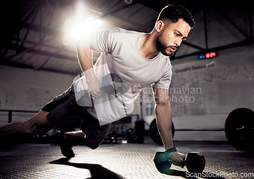 Image of Fitness, push up and man exercise with dumbbells at gym for training workout with focus. Serious male athlete or bodybuilder with weights for strong muscle, power or motivation for hard work on floor