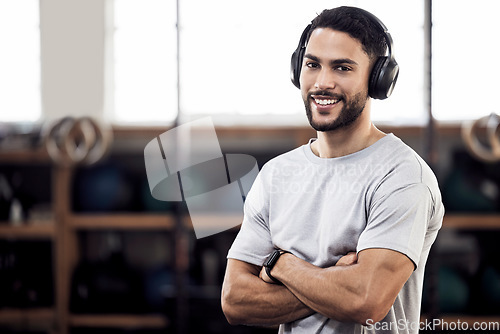 Image of Headphones, fitness and man listening to music at gym for exercise or training workout. Face portrait of happy male athlete listen to audio sound with tech for motivation, mindset and space to relax