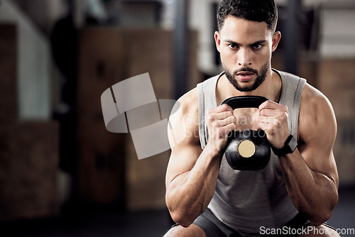 Image of Fitness, exercise and man squat with a kettlebell at gym for a training workout with focus. Serious male athlete or bodybuilder with weights for strong muscle, power and motivation with mockup space