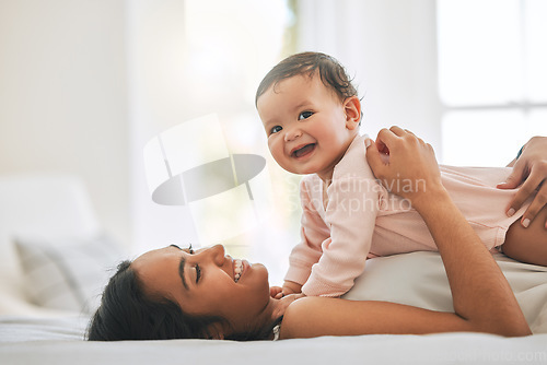Image of Mom lying, cuddle newborn and bedroom with smile, care and happiness in morning with love, bond or excited face. Young mother, baby and happy in bed, family home or holding kid with pride together