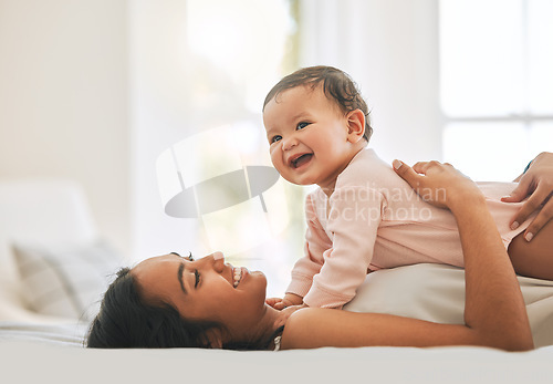 Image of Mother lying, embrace newborn baby and bed with smile, care or happiness in morning with love, bond or excited face. Young mom, kid and happy in bedroom, family home or holding with pride in sunshine