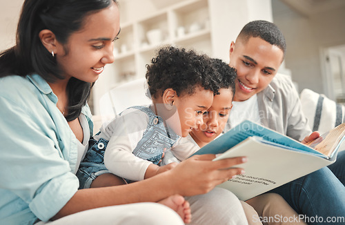 Image of Young happy family, children reading and sofa for story, book and learning together in home, love and bonding. Parents, education and kids on living room couch with smile, care and support in house