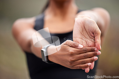 Image of Stretching hands, fitness and a woman in nature for running, workout and getting ready for cardio. Sports, health and a runner with a start for a run, exercise or training with a hand warm up