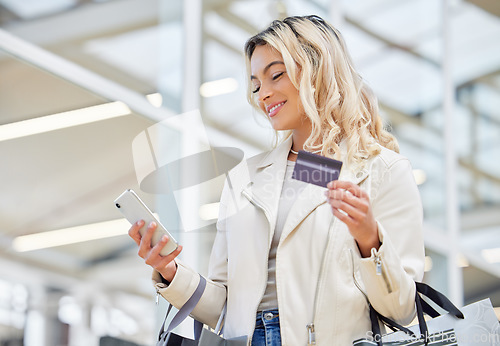 Image of Credit card, phone and a woman doing online shopping at a mall for retail sale and discount. Happy, ecommerce and a girl with easy pay on a mobile app while in a shop for a deal, payment or bag