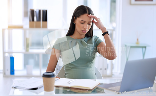 Image of Pregnant woman in office, stress headache at desk with laptop and small business research online. Pregnancy, fatigue and exhausted businesswoman working overtime on report at startup design company.