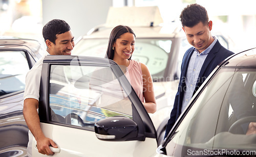 Image of Couple at car dealership, choice and transport with salesman, people buying new transportation with luxury. Happy with decision, man and woman at automobile showroom with purchase and browsing cars