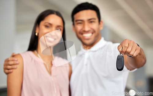 Image of Couple at car dealership, choice and key in hand with transportation, buying new vehicle with luxury and smile. Happy with decision, man and woman at automobile showroom with purchase and cars