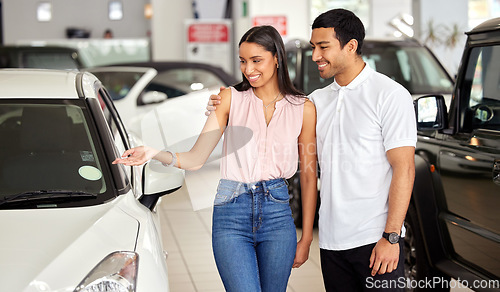 Image of Couple at car dealership, choice and transport with smile, people buying new vehicle with luxury and customer. Happy with decision, man and woman at automobile showroom, purchase and transportation