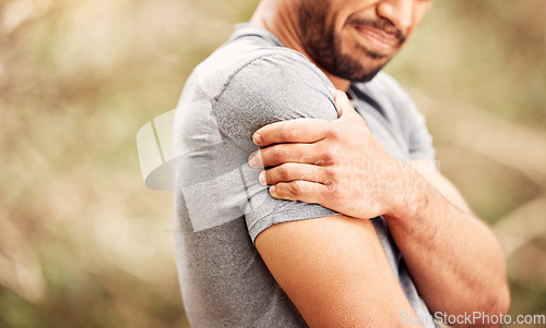 Image of Fitness, closeup and man with shoulder pain, nature and sports with exercise, muscle tension or health issue. Zoom, male person or athlete outdoor, medical problem or emergency with workout or injury