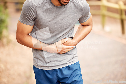 Image of Fitness, stomach ache and man outdoor after running, workout or exercise. Sports, abdominal pain and male athlete in nature with injury, emergency or problem, sick or hernia after training mockup.