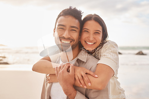 Image of Portrait, hug and couple at the beach with happiness for a vacation in the summer having fun. Together, hugs and ocean for holiday with smile for the weekend with sunshine for relaxing and bonding.