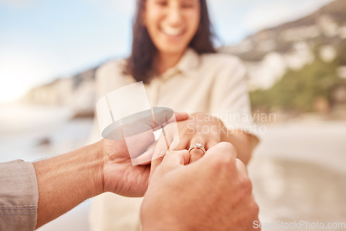 Image of Pov, engagement and woman with ring on hand at beach with smile, love and happy couple vacation. Man, woman and jewelry with marriage offer by ocean with diamond, excited face or together on holiday