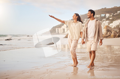 Image of Mockup, pointing and a couple holding hands on the beach while walking together on a date for romance. Love, happy or smile with a man and woman taking a romantic walk by the coastal ocean or sea