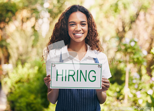 Image of Portrait, smile and woman with hiring sign for employment, career or job opportunity. Face, recruitment poster and African female business owner, florist and advertising interview, hire or onboarding