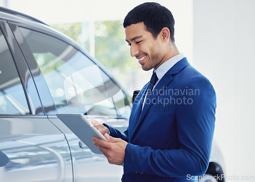 Image of Tablet, car and salesman smile at showroom, workshop or salon workplace. Internet, technology and male person at dealership for motor vehicle shopping, web scroll and email app in auto retail store.