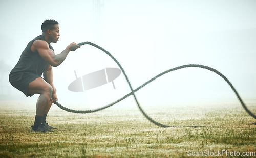 Image of Exercise, battle rope and black man on field for power workout for body building, training and muscle strength. Fitness, sports and bodybuilder on grass with ropes, energy and outdoor sport in mockup