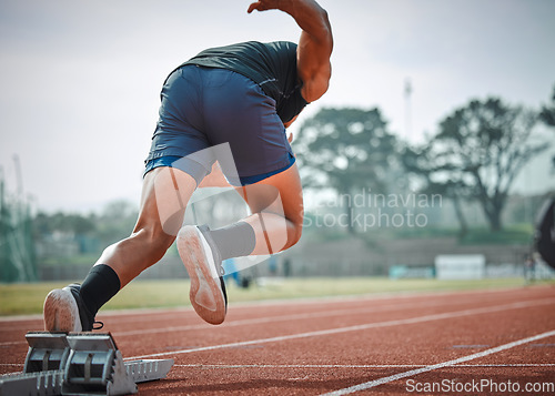 Image of Stadium, man running and start block of athlete on a runner and arena track for sprint race training. Back, run and sports exercise of male person in marathon for fitness and workout outdoor on field