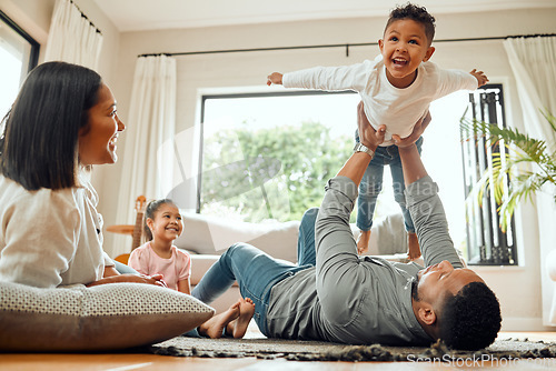 Image of Family, father lifting son and playing in living room with fun and mother with daughter bonding at home together. Happy people with love, care and carefree, airplane and parents relax with kids