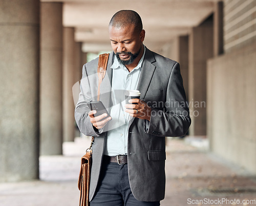 Image of Cellphone, coffee and businessman in city commuting to corporate office while networking. Travel, town and African male employee browsing on social media, mobile app or internet while walking to work