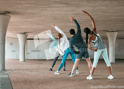 Image of Group, workout and team stretching as a fitness club for sports, health and wellness in a class together. Sport, commitment and friends training or people doing pilates exercise or yoga as teamwork