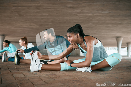 Image of Group, training and friends stretching as a fitness club for sports, health and wellness in an urban town together. Sport, commitment and people exercise or team doing warm up workout in a city