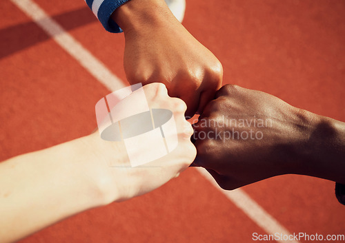 Image of People, diversity and fist bump in fitness for teamwork, unity or trust together on stadium track above. Hands of group touching fists in team building for sports motivation, agreement or goals