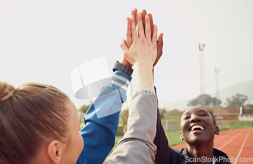 Image of People, diversity and high five in fitness for teamwork, unity or trust together on stadium track. Happy athlete group touching hands in team building for sports motivation, support or goals outdoors