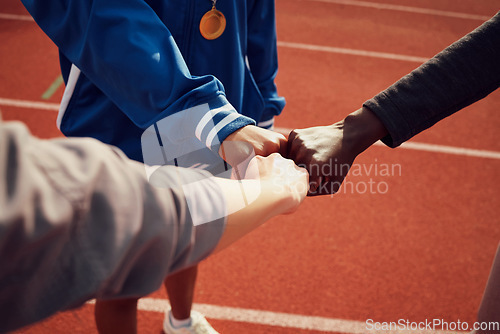 Image of People, diversity and fist bump in fitness for unity, trust or support together on stadium track. Hands of group touching fists in team building for sports motivation, teamwork or goals outdoors