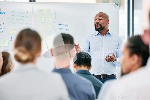 Image of Male speaker, conference and corporate team at training for company with learning on a board with audience. Business, presentation and coach is speaking to employees during a meeting at the office.