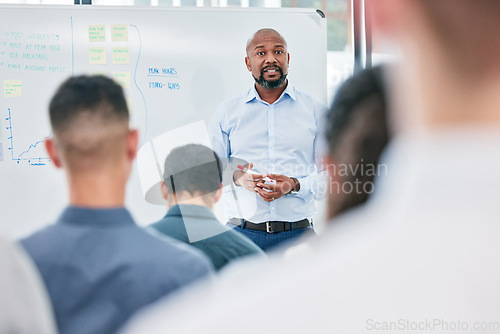 Image of Presentation, business and speaker with audience at the office for learning about work. Conference, coach and employees are training during a meeting at a company on a board for corporate team.