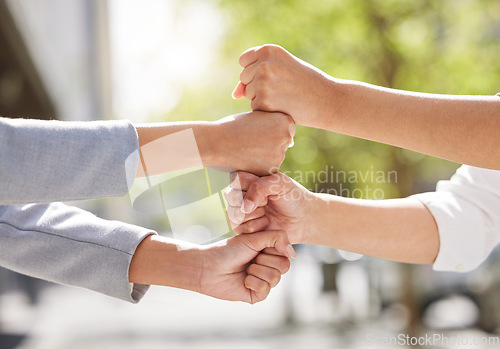 Image of Fists, team building or business people in city for collaboration for mission goals in a deal. Motivation, fist bumping closeup or employees with goals together, teamwork or support outdoors in park
