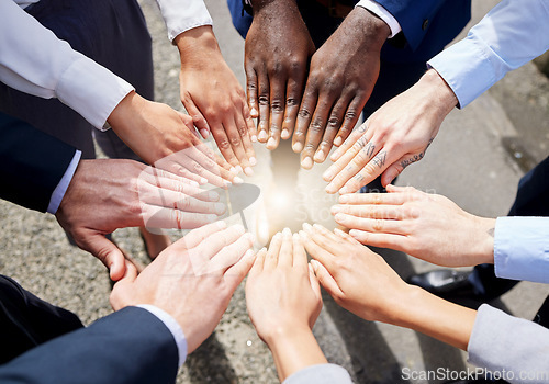 Image of Hands, teamwork or top view of business people outside in collaboration for mission goals in city. Light, link or employees meeting with strategy, teamwork or support outdoors together in huddle