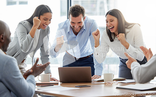 Image of Success, businesspeople with celebration and in office of their workplace with a lens flare. Achievement or good news, happiness and colleagues happy celebrating or cheering at their workstation