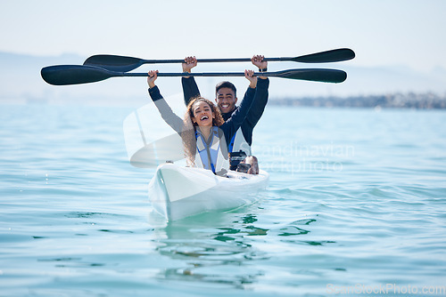 Image of Kayak, sports and team celebrate win on rowing boat on a lake, ocean or river for fitness challenge. Man and woman or winning couple with a paddle for adventure, teamwork exercise or travel on water