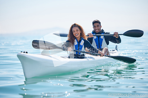 Image of Kayak, rowing boat and couple on a lake, ocean or river for water sports and fitness challenge. Portrait of man and woman with a paddle and smile for adventure, teamwork exercise or travel in nature