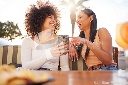 Image of Laughing, happy and women with a phone at a cafe for a meme or social media notification. Smile, talking and friends with a mobile for a funny app, comic conversation or comedy together at restaurant