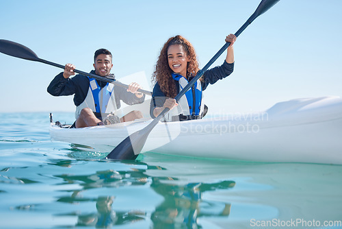 Image of Couple, kayak and rowing boat on a lake, ocean or river for water sports and fitness challenge. Portrait of happy man and woman with a paddle for adventure, exercise or travel in nature with teamwork