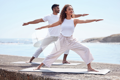 Image of Couple yoga, beach and exercise outdoor in nature for fitness workout and wellness. African woman and a man at ocean for warrior pose, stretching or pilates training for peace, freedom or mindfulness