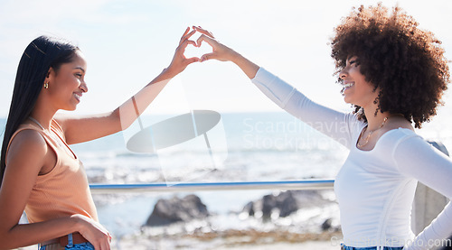 Image of Friends, heart and hands with women at beach for summer, happy and teamwork. Support, freedom and love with people and holding shape in outdoors for collaboration, faith and community gesture