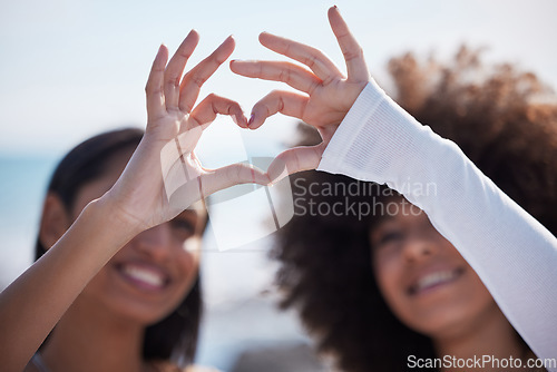 Image of Friends, closeup and heart hands with women at beach for summer, happy and teamwork. Support, freedom and love with people and holding shape in outdoors for collaboration, faith and community gesture