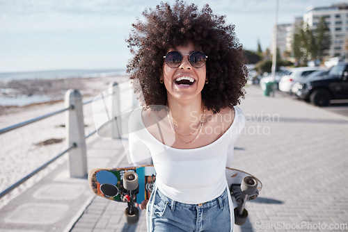 Image of Woman, happy and outdoor with a skateboard for travel, adventure and freedom on a beach road. Face of comic african person laugh on promenade for tropical vacation or skating with sunglasses in Miami