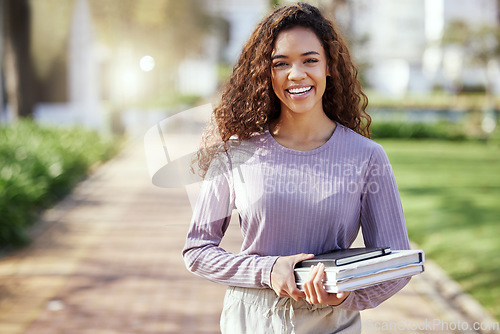 Image of Woman with smile, books and education with student on campus, learning with scholarship at university and outdoor. Female person in portrait with smile, college course material and mockup space