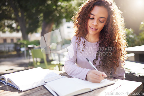 Image of Writing, studying and woman with books outdoor in park, cafe or university campus, notes or exam goals. Planning, ideas and african person or college student for remote work, scholarship and notebook