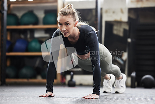 Image of Fitness, push up and woman in gym for exercise, bodybuilder training and strong muscles. Healthy body, sports center and female person do pushup on floor for wellness, performance and cardio workout
